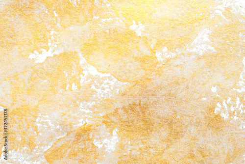Aged texture created with gold acrylic paint. Festive background.