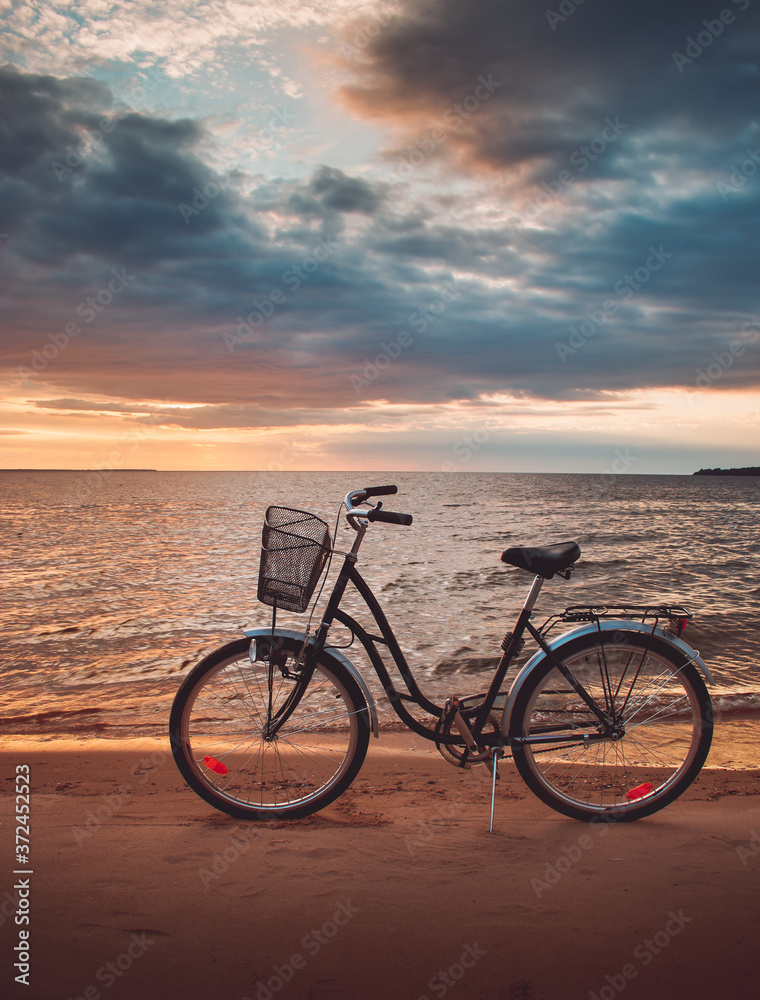 Lonely bike standing at sunset at seaside