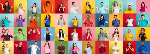 Collage of portraits of 38 young emotional people on multicolored background. Concept of human emotions, facial expression, sales. Smiling, heart gesture, thumb up, happy, celebrating, pointing