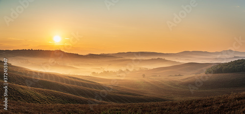 Beautiful sunrise over the Tuscany hills and fields. Travel destination Tuscany