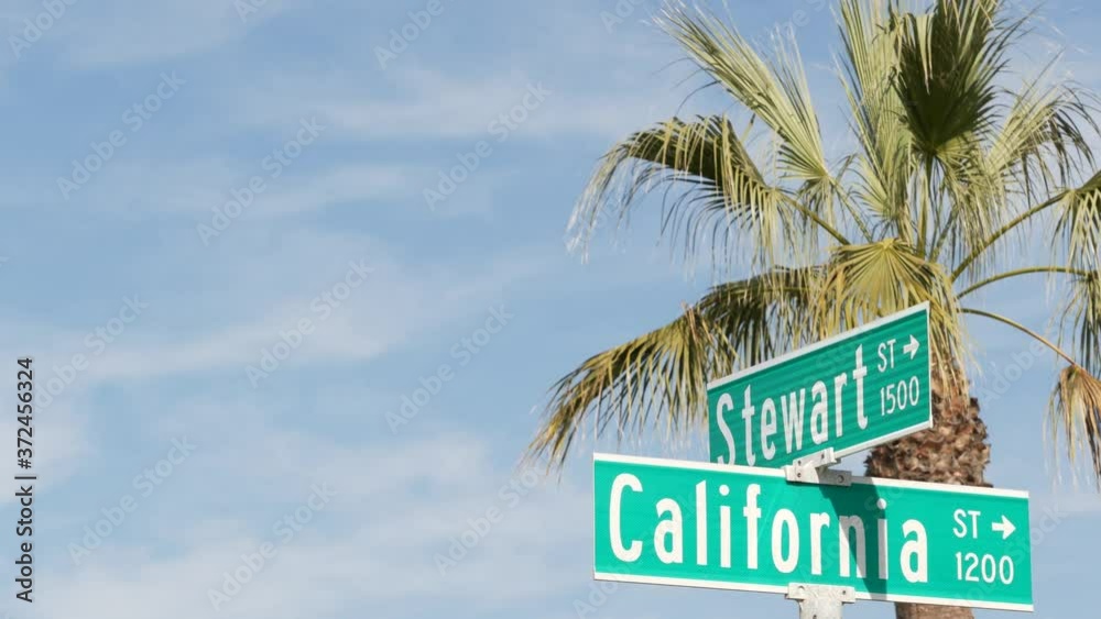 California street road sign on crossroad. Lettering on intersection signpost, symbol of summertime travel and vacations. USA tourist destination. Text on nameboard in city near Los Angeles, route 101.