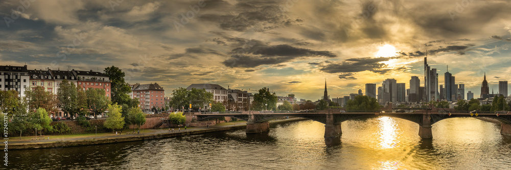 high resolution photo with the sun shining over buildings during frankfurt germany sunset