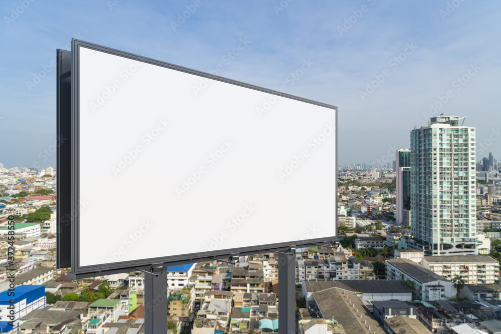 Fototapeta premium Blank white road billboard with Bangkok cityscape background at day time. Street advertising poster, mock up, 3D rendering. Side view. The concept of marketing communication to promote or sell idea.