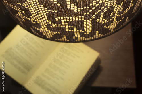 Open Book Under a Table Lamp