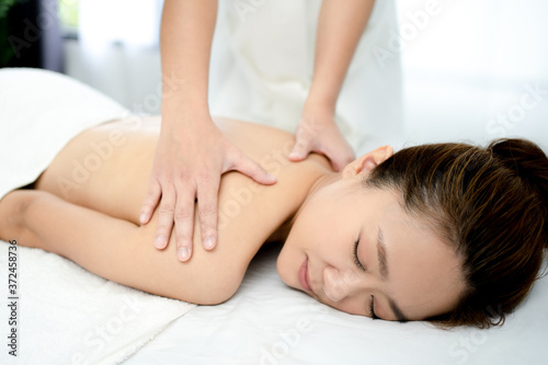 Young woman having a relaxing massage in a spa salon