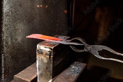 Forging molten metal. Making knives.
