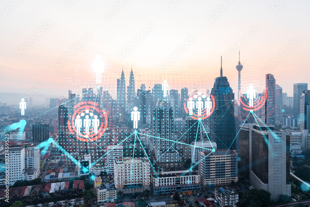 Fototapeta Hologram of social media icons over sunset panoramic cityscape of Kuala Lumpur, Malaysia, Asia. The concept of people connections in KL. Multi exposure.