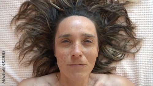 4K Witchy middle aged woman with natural face looks on camera in her bitchy way
