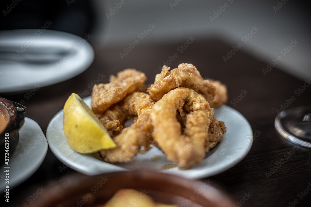 portion of fried squid on the restaurant table portion of fried squid on the restaurant table