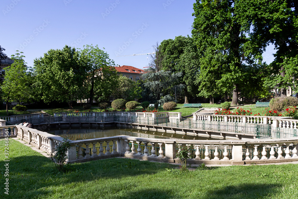 Milan - Guastalla Garden, view on the baroque fishpond enclosed by an elegant granite balustrade. Lombardy
