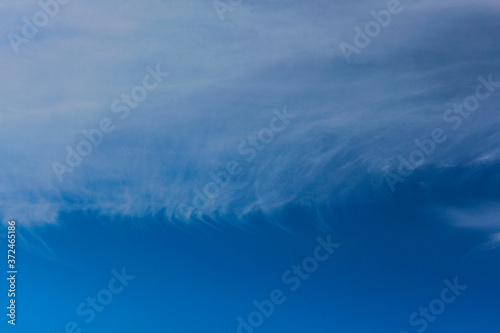 Blue sky with white clouds of unusual shape