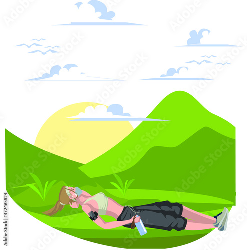 A woman laying down on the grass for resting after morning jogging