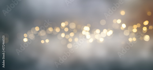 Golden bokeh background with fog Abstract golden bokeh background with blur effects and sparks for a glamorous holiday concept.