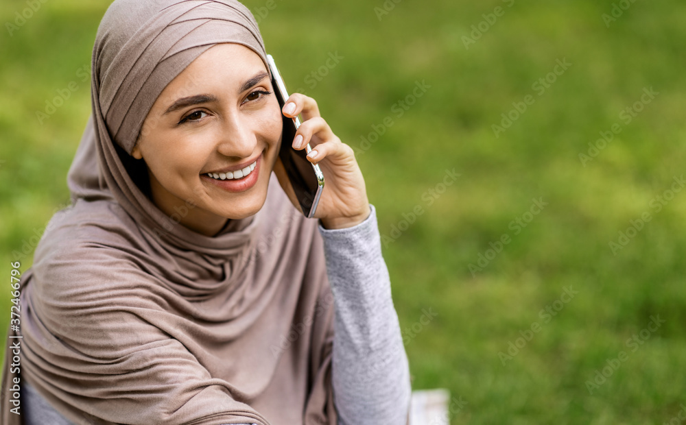 Closeup portrait of young happy arab woman talking on phone Closeup portrait of young happy arab woman talking on phone