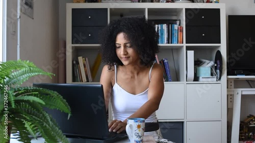 woman teleworking at home while her children playing