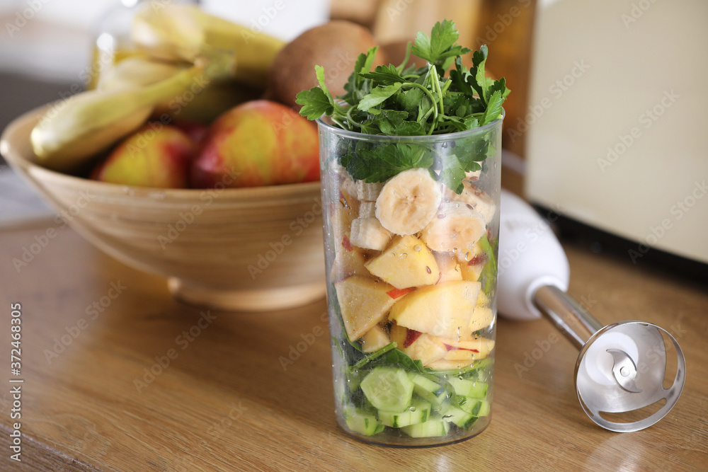 Glass of delicious yogurt with mint and fresh strawberries, banana, lime, nectarine in a wicker basket on a wooden table Glass of delicious yogurt with mint and fresh strawberries, banana, lime, nectarine in a wicker basket on a wooden table
