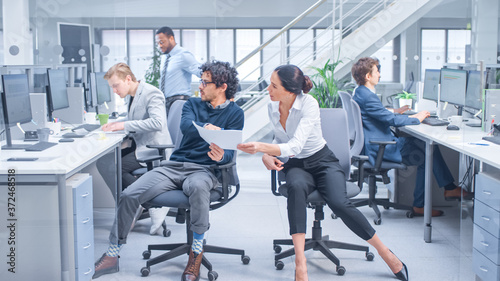 Diverse Team of Business Managers and Specialists Work on Desktop Computers with Two Rows of Tables Side by Side. Young and Motivated Business people in Modern Open Office.