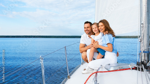 Family Sailing In Sea Sitting On Sailboat Deck Outdoors, Panorama