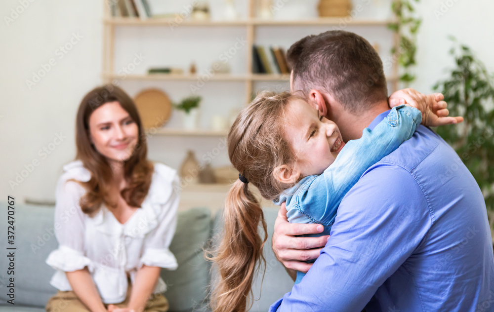 Cute Dad And Daughter Hugging In Front Of Mother Indoor Cute Dad And Daughter Hugging In Front Of Mother Indoor