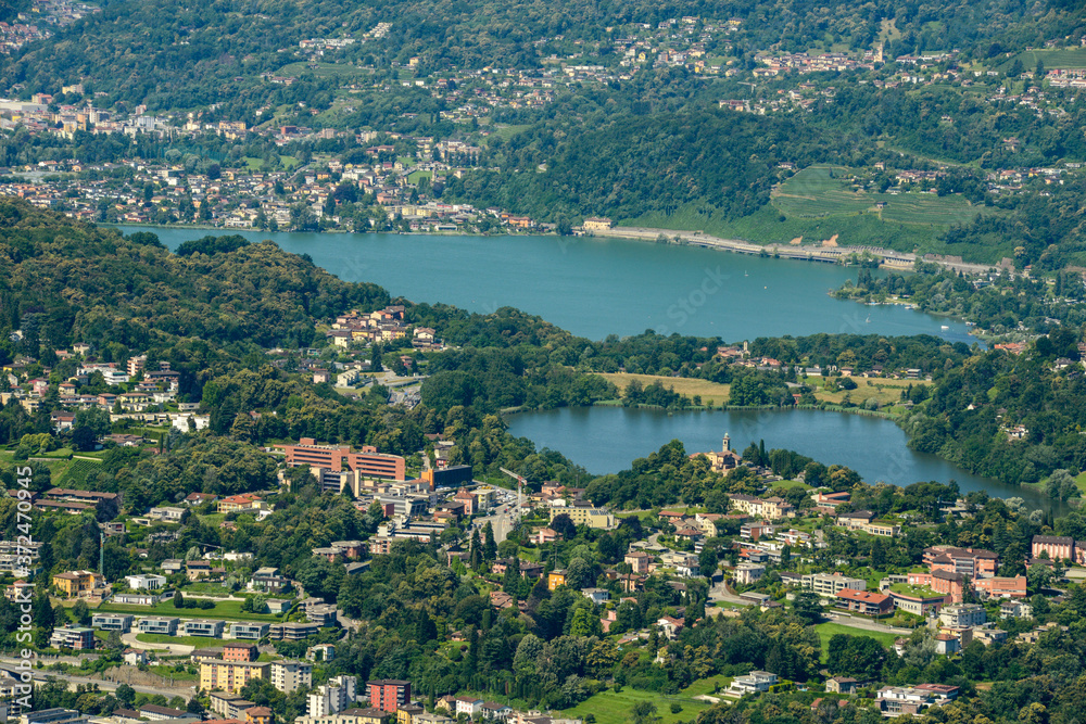 Aerial view of lake Muzzano and Lugano in Switzerland