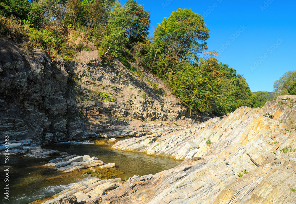 Dry rocks on river bank. Drought on the river Prut. Western Ukraine