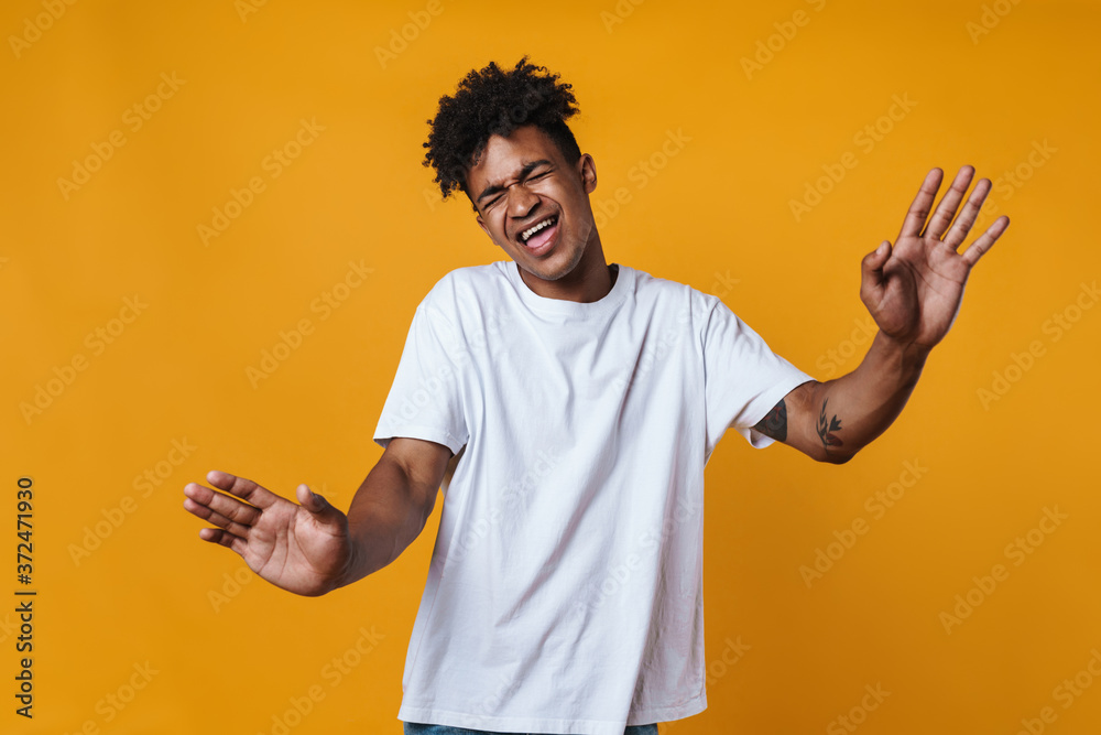 Image of happy african american guy singing and dancing on camera Image of happy african american guy singing and dancing on camera