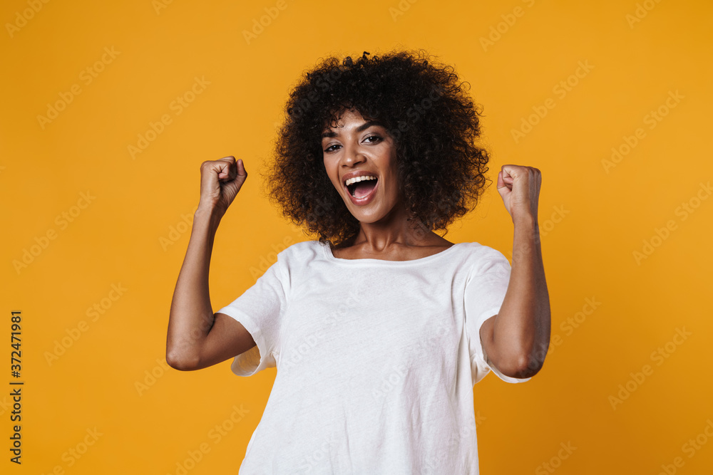 Image of excited african american girl making winner gesture Image of excited african american girl making winner gesture
