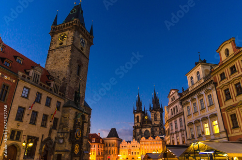 Prague Old Town Square (Stare Mesto) historical city centre. Astronomical Clock (Orloj) and Tower of City Hall building, Gothic Church of Our Lady before Tyn, evening view, Bohemia, Czech Republic