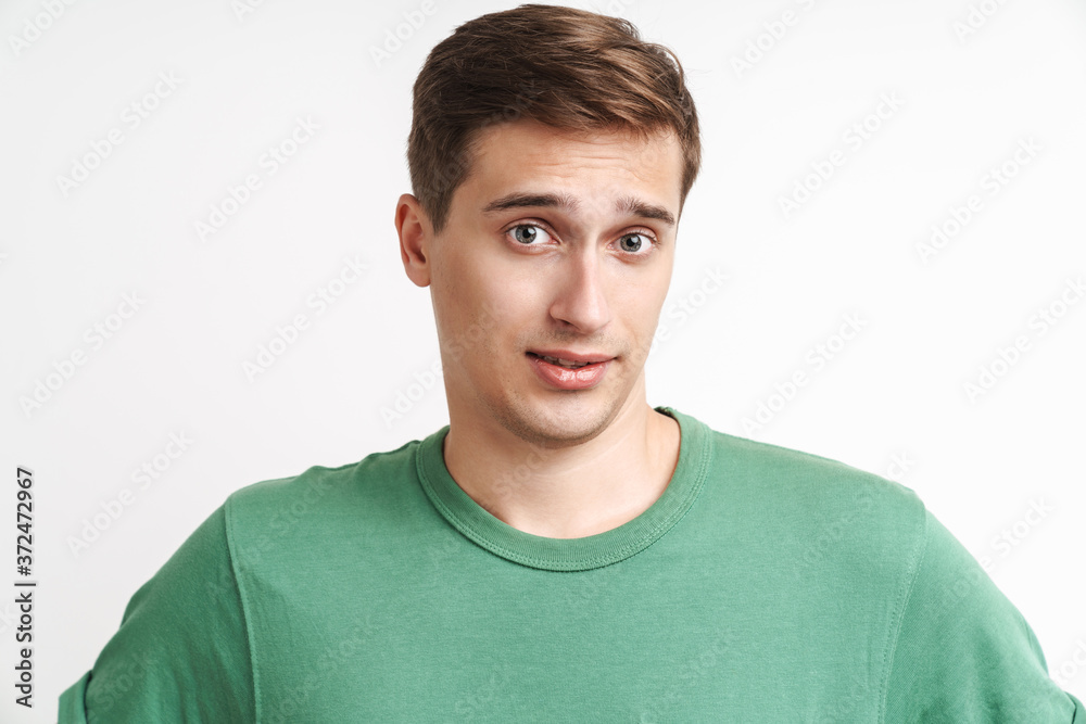 Image of uptight caucasian man resenting and looking at camera Image of uptight caucasian man resenting and looking at camera