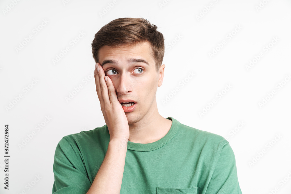 Image of puzzled caucasian man being stressed and grabbing his face Image of puzzled caucasian man being stressed and grabbing his face