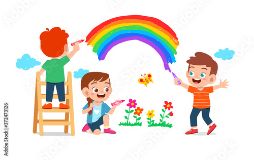 happy cute little kid boy and girl draw with paint on wall together