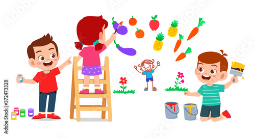 happy cute little kid boy and girl draw with paint on wall together