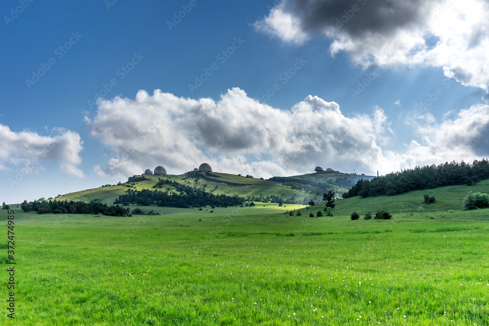 A huge green field of grass under blue sky