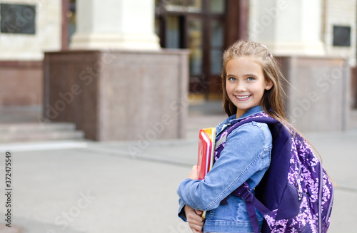 Back to school. Education concept. Cute smiling schoolgirl preteen on the way to the school.