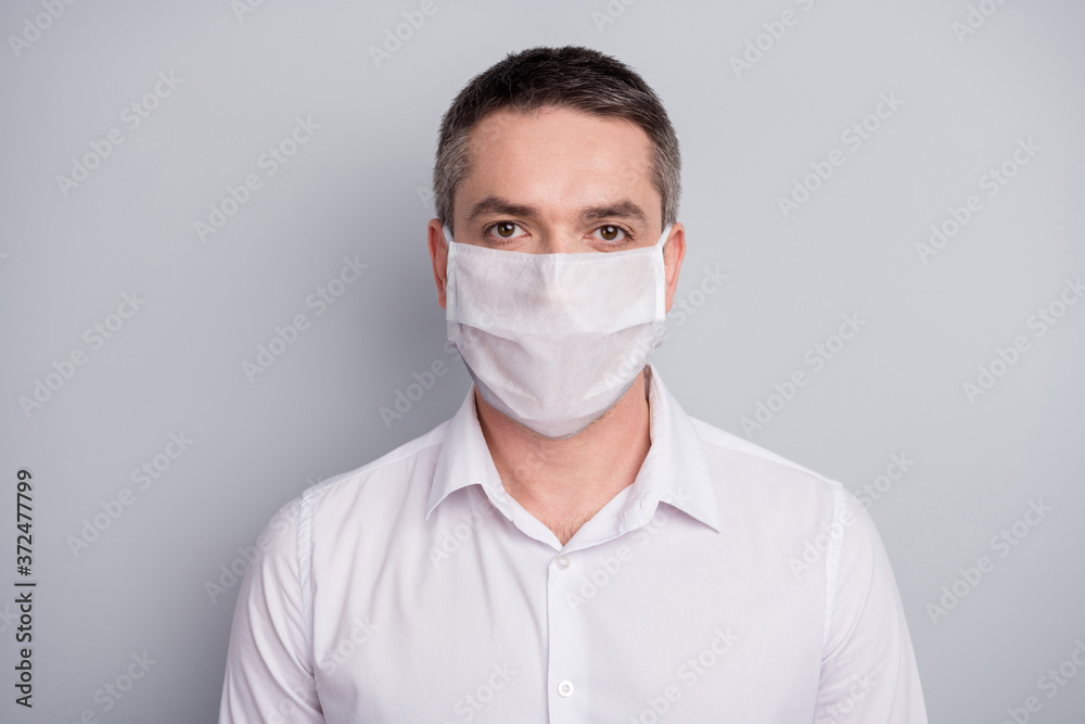 Close-up portrait of his he nice attractive serious mature guy wearing safety mask stop viral pneumonia contamination china wuhan disease isolated light gray pastel color background Close-up portrait of his he nice attractive serious mature guy wearing safety mask stop viral pneumonia contamination china wuhan disease isolated light gray pastel color background