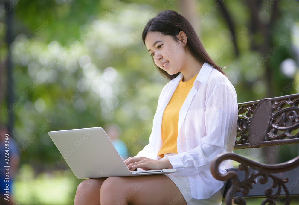 Business women relax and work in the park on vacation Business women relax and work in the park on vacation