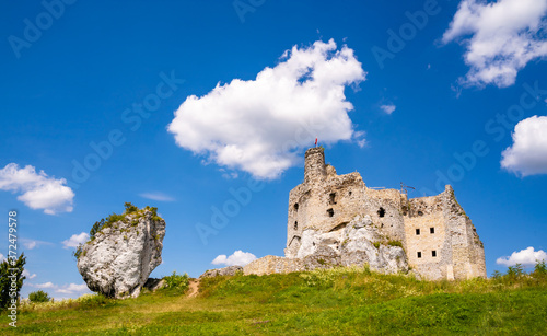 14th century ruins of Mirow Castle in Poland. Medieval, monumental, stone building lies on a hill, surrounded by limestone rock formations. A romantic castle in the Eagle Nests trail. Sunny summer sky