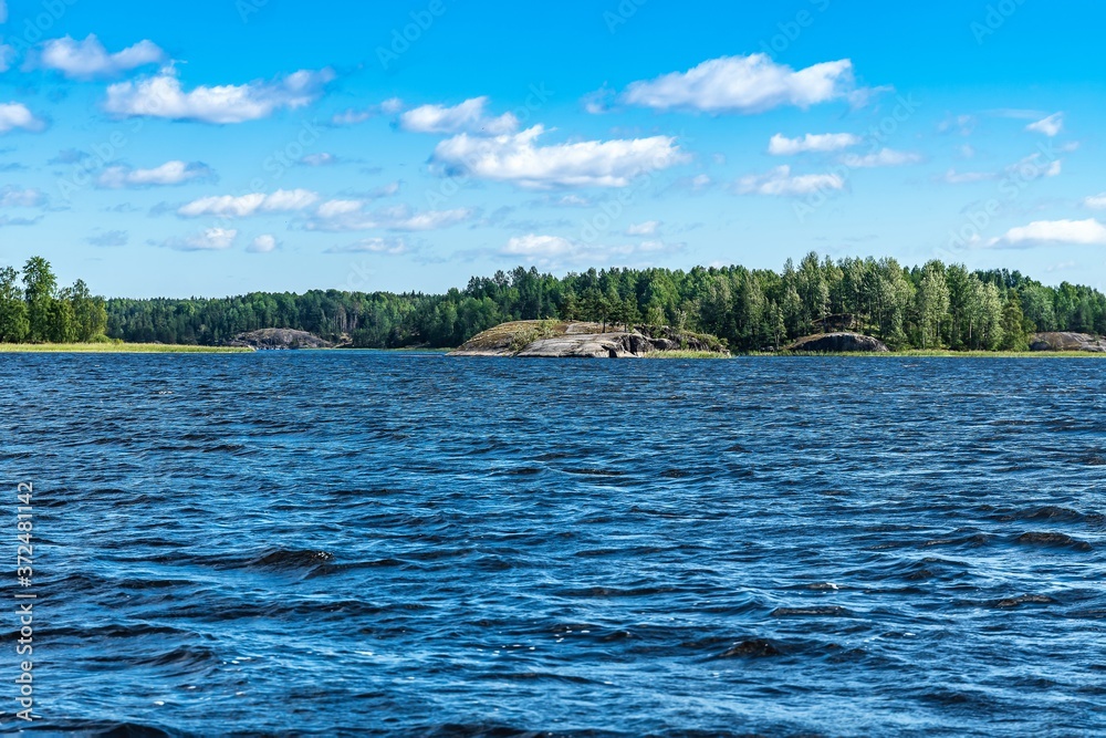 Russia, Lake Ladoga, August 2020. The distant shore of the lake, taken from the boat.