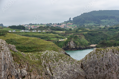 Views of the town of Prellezo in Cantabria from the coast with the mountains in between photo