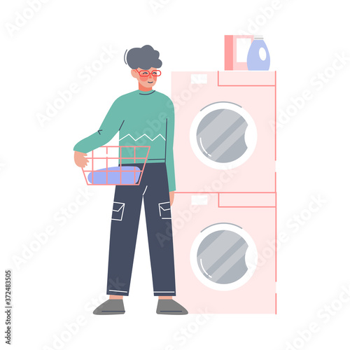 Young Man Doing Laundry at Home or Public Laundrette, Guy Holding Basket of Dirty Clothes Standing Beside Washer and Dryer Flat Style Vector Illustration