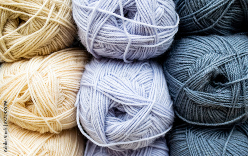 Close-up of skeins of ivory thread, blue and gray pastel colors. Thread background