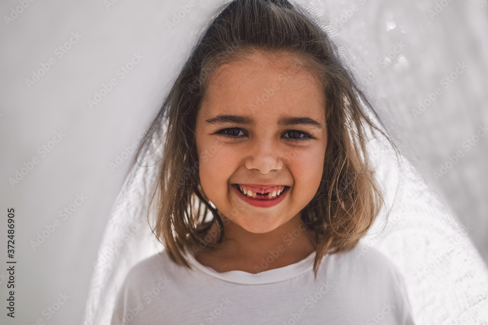 Happy child. Funny girl playing with a blanket. Smiling child girl. Cheerful child outdoors in nature Happy child. Funny girl playing with a blanket. Smiling child girl. Cheerful child outdoors in nature