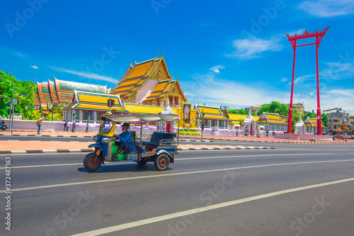Background of one of the major tourist attractions in Bangkok(Wat Suthat Thepwararam)with beautiful churches and pagodas,popular people come to make merit and take pictures during holidays in Thailand