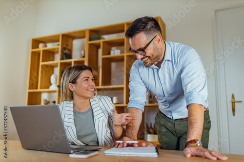 Woman dressed casually and man dressed in suit.