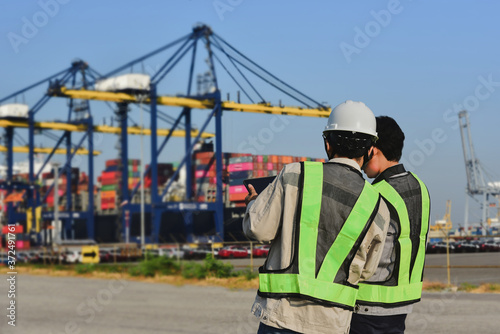 Dock workers with digital tablet at Port on