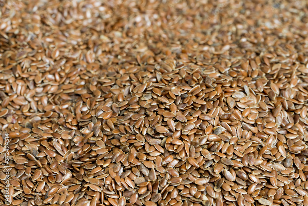 heap of brown flax seeds closeup selective focus
