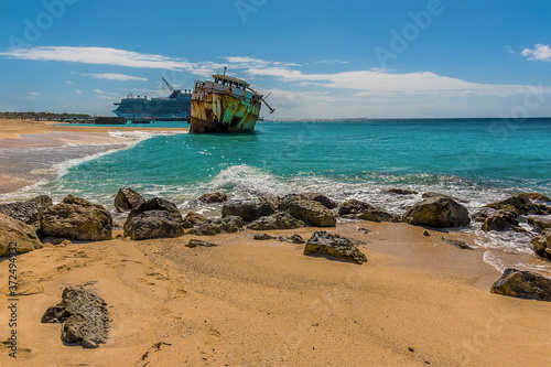 A ring of rocks in front of a shipwreck on Governors beach on Grand Turk photo