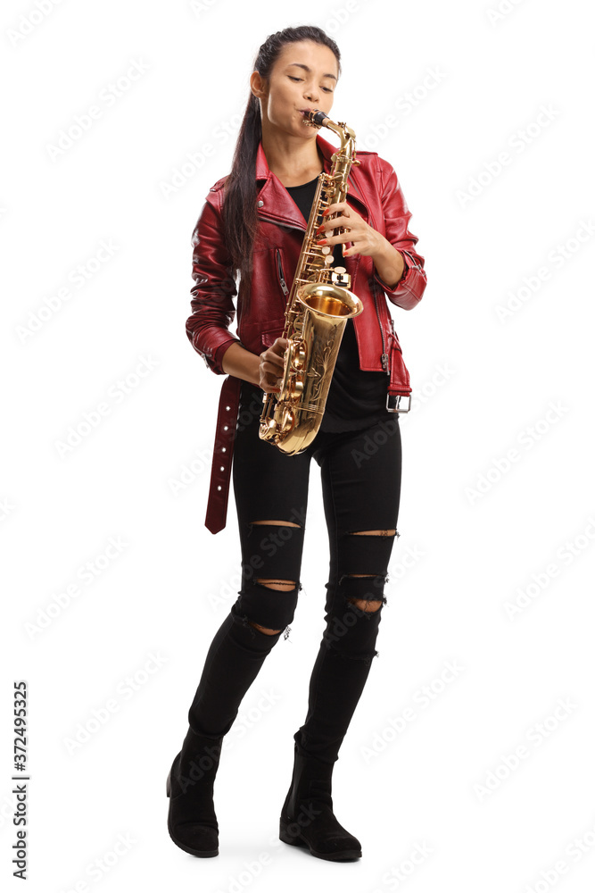 Fototapeta premium Full length portrait of a female saxophonist in a red leather jacket playing a saxophone