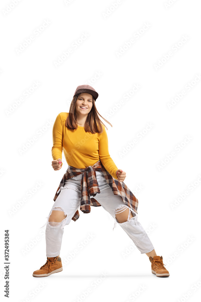 Full length shot of a young lady dancing street style Full length shot of a young lady dancing street style