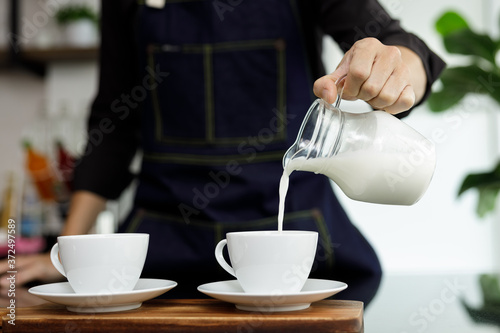 coffee maker pours milk mixed with hot coffee